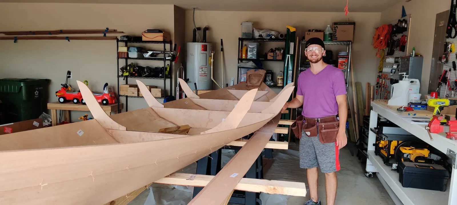 Wire stitches holding the pre-cut okoume planks of a Northeaster Dory together on sawhorses