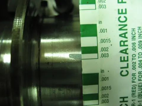 Hot Rod: 355 engine: To check the main bearing oil clearance, we cut a plastigauge strip and placed it on the c