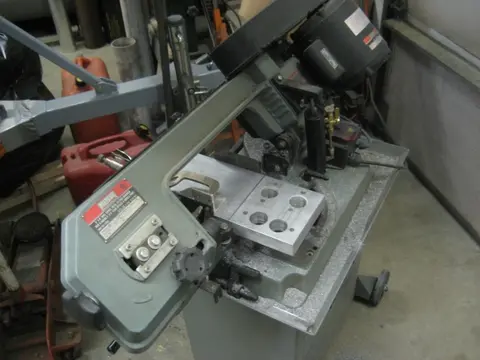 Hot Rod: Exhaust: To help tune our carbureted engine, we fabricated aluminum spacer blocks to mount a wideba
