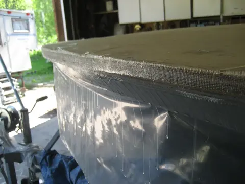 Hot Rod: Deck: With the deck plywood installed, it's time to build up two layers of ten ounce fiberglass