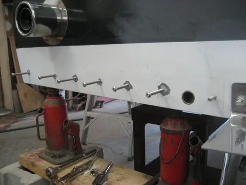 Hot Rod: Cavitation plates: A 9/32" pilot hole was bored followed by a 5/16" tap to thread the bolt hole